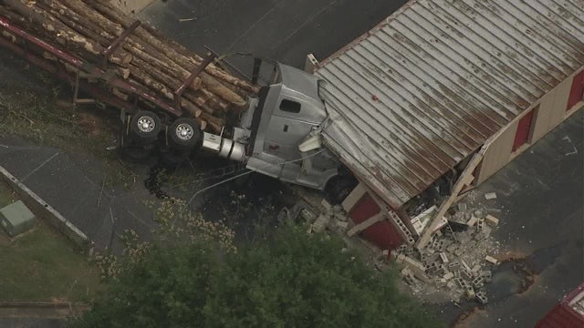 Crews respond to building where tractor-trailer hauling lumber crashed in DeKalb County