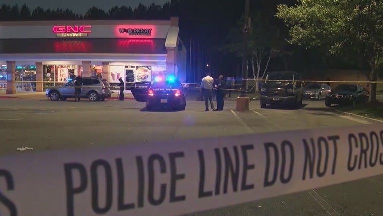 Police investigate a double shooting at a shopping center along Flat Shoals Road on June 12, 2022.