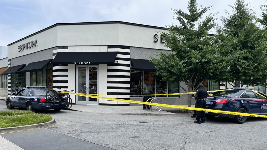 Police investigate after a bullet went through the window of a popular Buckhead cosmetics shop on June 7, 2022.