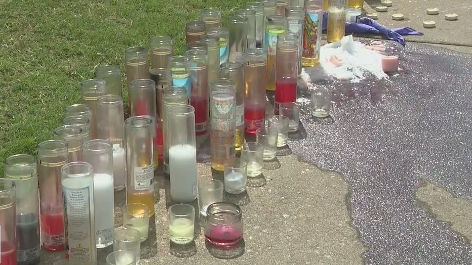 Candles surround a makeshift memorial at a DeKalb County grocery store where a teen was killed on June 12, 2022.