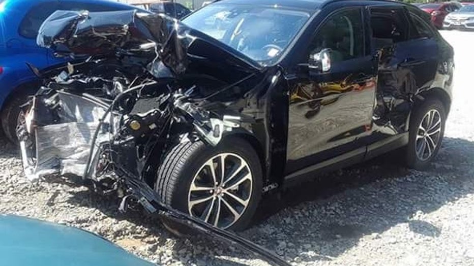 A crumpled SUV sits in a parking lot.