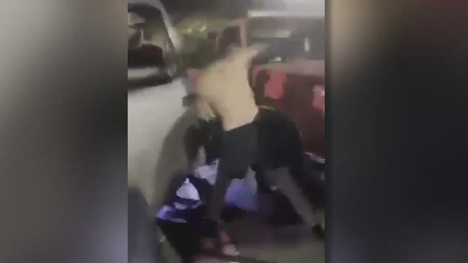 In this image from a video posted several times on social media, a Central High School graduate can be seen being jumped by several other teens in the parking lot of a Carrollton store.