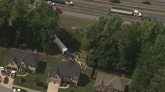 Semi-truck crashes through backyard near I-20