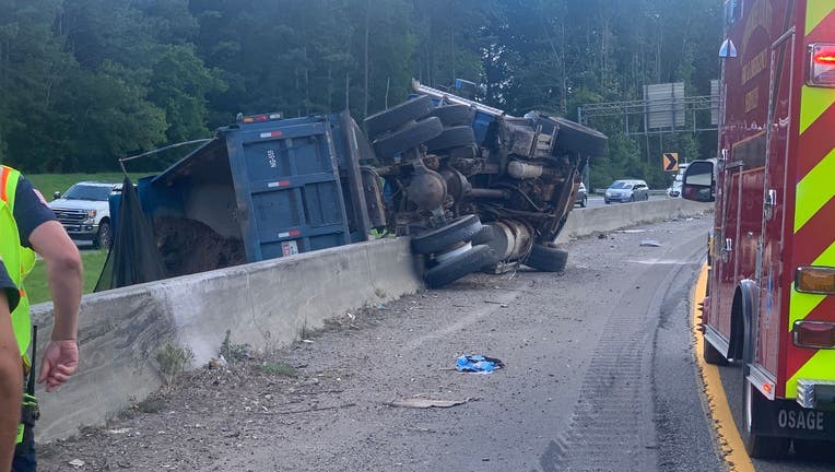 An overturned dump truck on I-575 north near the Hickory Flat Highway overpass.