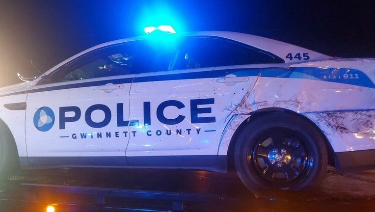 Police said a driver crashed into Gwinnett County police patrol cars early Sunday morning near the Jimmy Carter Boulevard exit on Interstate 85 northbound.