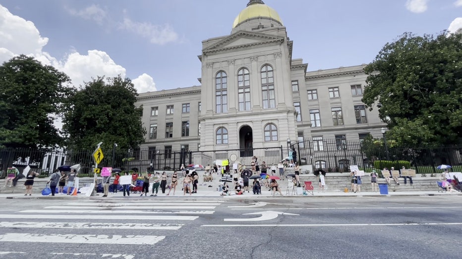 Two groups of protestors in favor of the right to abortion are occupying areas outside state buildings on July 4 in Downtown Atlanta, calling on Attorney General Chris Carr to stop courts from implementing Georgia's abortion restriction. 