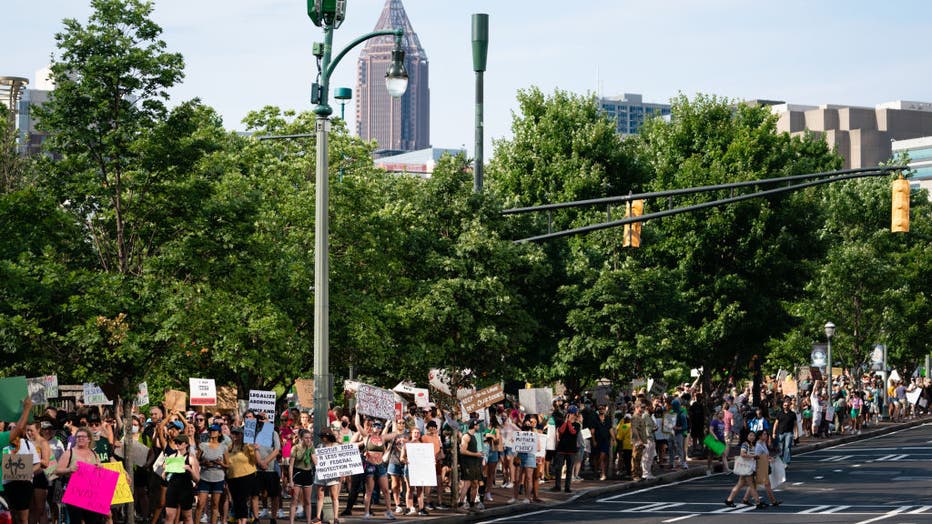 ATLANTA, GA - JUNE 25: People march during a protest against the Supreme Court's ruling in the Dobbs v Jackson Women's Health Organization on June 25, 2022 in Atlanta, Georgia. The Court's decision in the Dobbs v Jackson Women's Health case overturns the landmark 50-year-old Roe v Wade case, removing a federal right to an abortion. (Photo by Elijah Nouvelage/Getty Images)