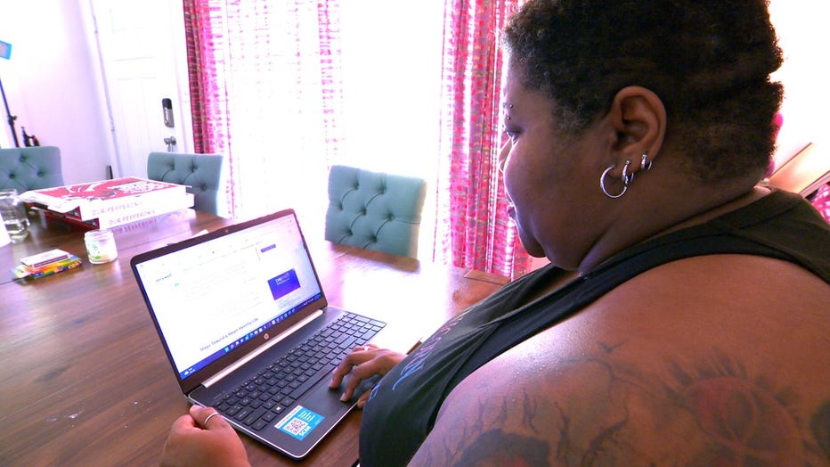 Woman looks at laptop computer