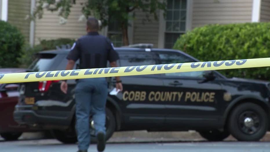 Cobb County police investigate a triple shooting that left two people dead at an Austell apartment on July 11, 2022.