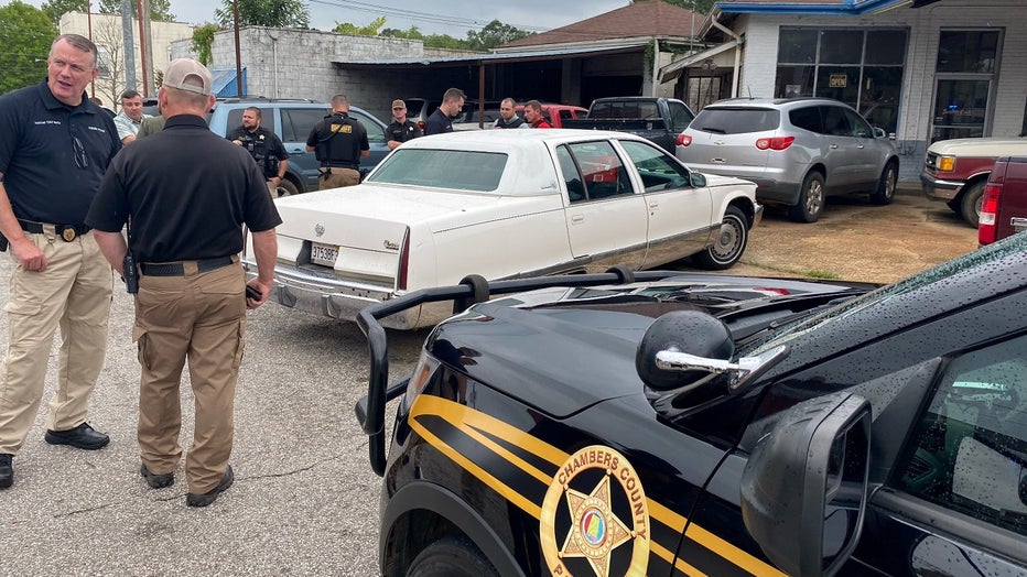 Law enforcement surround the vehicle near the courthouse in LaFayette, Alabama reportedly connected to a series of shootings along I-85 in Alabama and Georgia that injured at least one man on August 17, 2022.