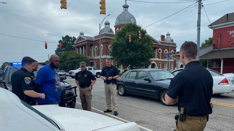 Law enforcement takes 39-year-old Jerel Raphael Brown into custody near the courthouse in LaFayette, Alabama on August 17, 2022.