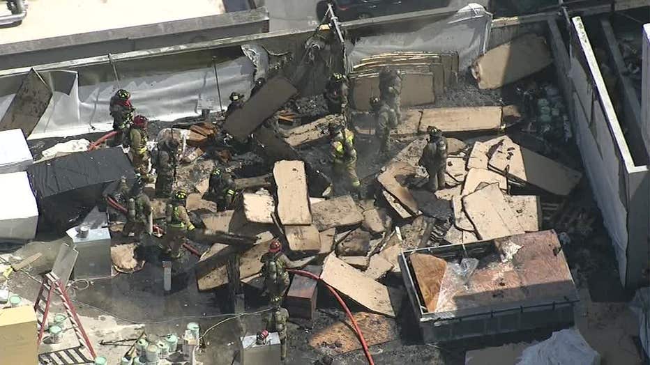 Firefighters sifting through debris on the rooftop of a smoking Downtown Atlanta building on Aug. 31, 2022.