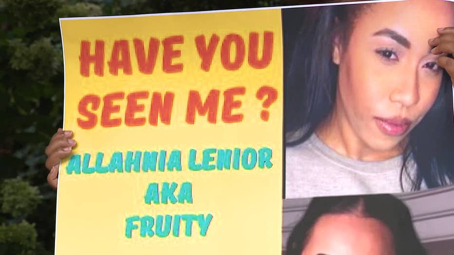 Friends and family of Allahnia Lenoir hold signs during a prayer vigil on Aug. 7, 2022 in Midtown.