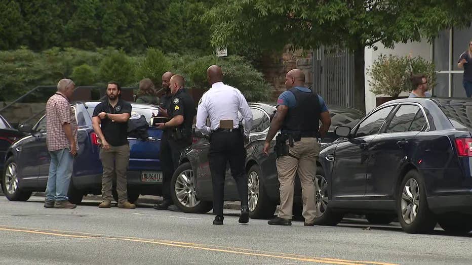 Atlanta police surround a building where the man believed to have vandalized Midtown’s iconic rainbow crosswalk was located on August 19, 2022.