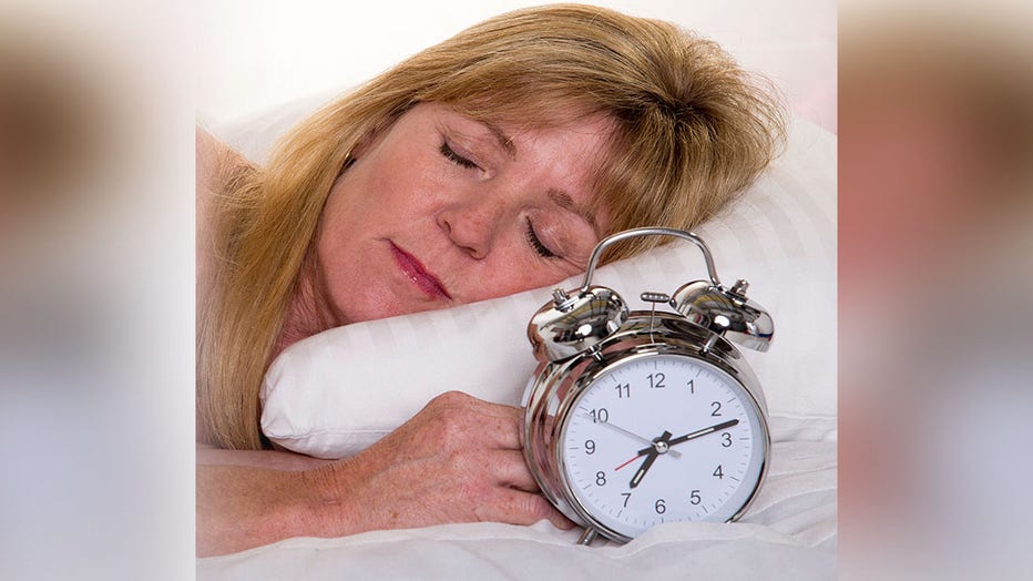 Woman-sleeping-alarm-clock.jpg
