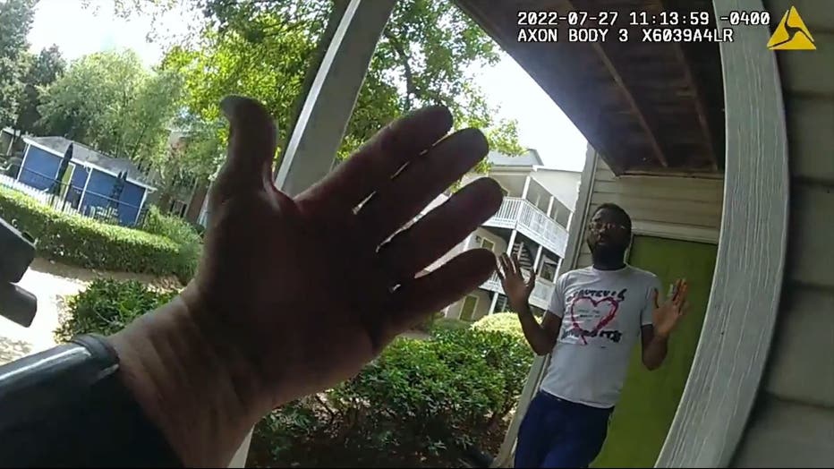 A member of the Atlanta Police Department Fugitive Unit waves Demetrius Beck out of an apartment before taking him into custody on July 27, 2022.