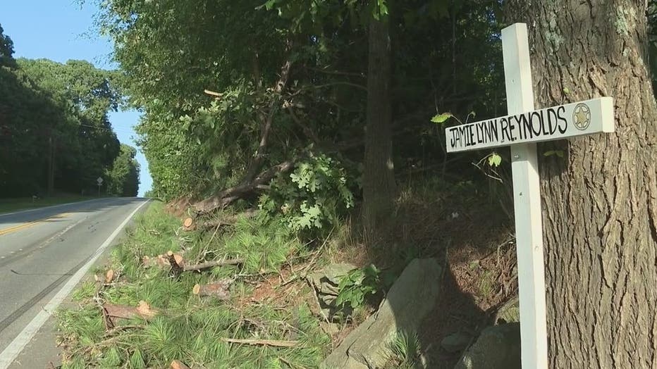 A cross marks the spot where Spalding County Sheriff's Office Deputy Jamie Reynolds was killed by a falling tree along GA-16 near Shoal Creek Road on July 31, 2022.