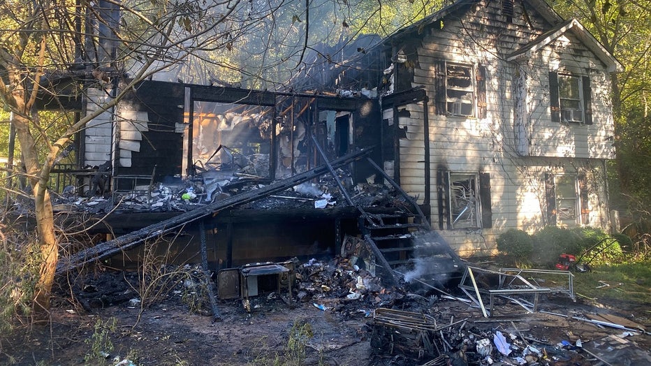 Paulding County firefighters investigate after a blaze tore through a home killing a teen and injuring another on Sept. 23, 2022.