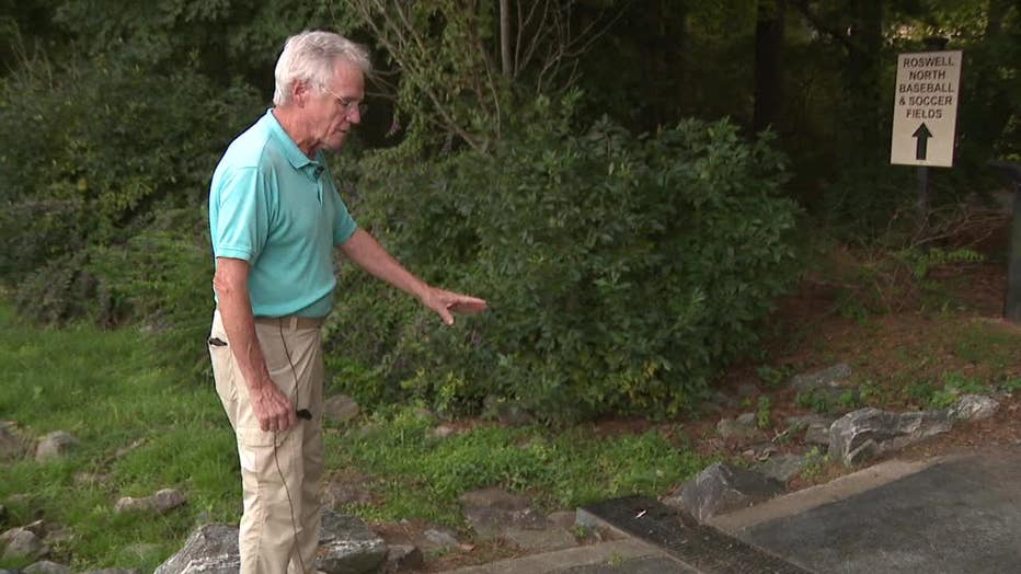 Dean Donald points out the blood stains in the area where his son was found beaten unconscious at Roswell Area Park on Sept. 13, 2022.