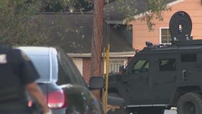 SWAT standoff: Man arrested after threatening woman, holding 2 juveniles in home, police say