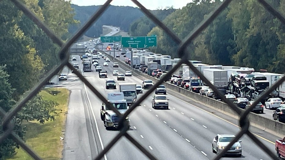 Traffic along I-285 west near I-675 comes to a stop after a shooting and traffic crash in DeKalb County on Oct. 11, 2022.