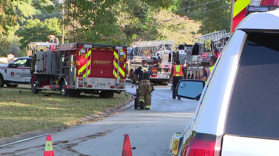 Gwinnett County firefighters battle a blaze at a home on Kings Circle NW near Lawrenceville on Oct. 5, 2022.