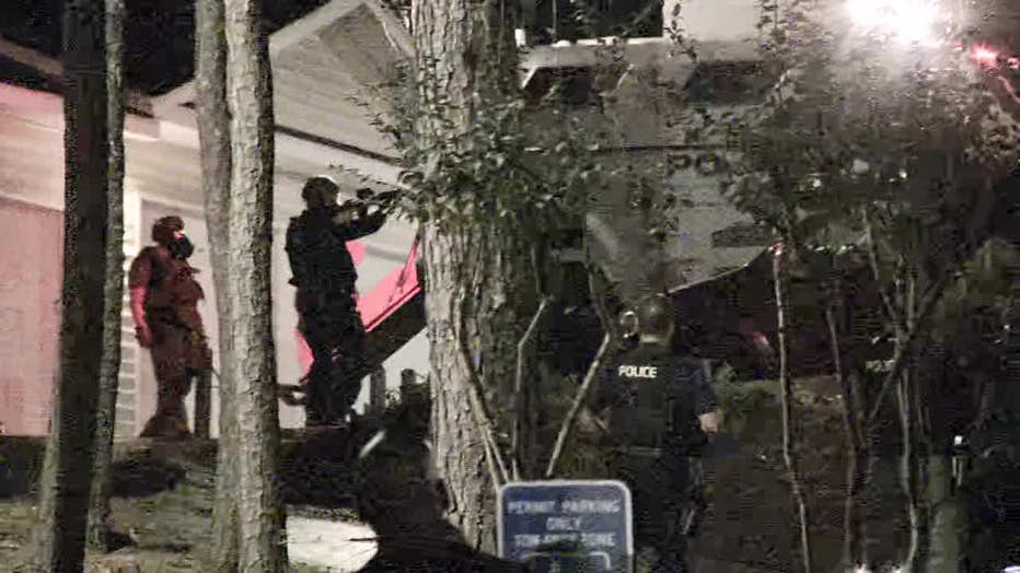 A SWAT team surrounds a Marietta apartment with a suspect barricaded inside on Oct. 13, 2022.