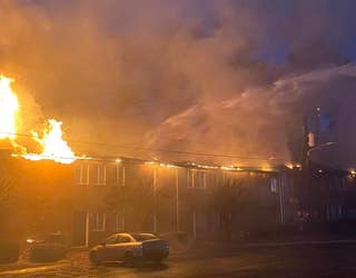Fire tears through a building at the University Oaks apartments on Nov. 18, 2022.