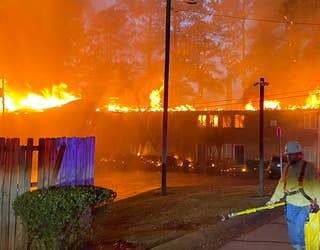 Fire tears through a building at the University Oaks apartments on Nov. 18, 2022.