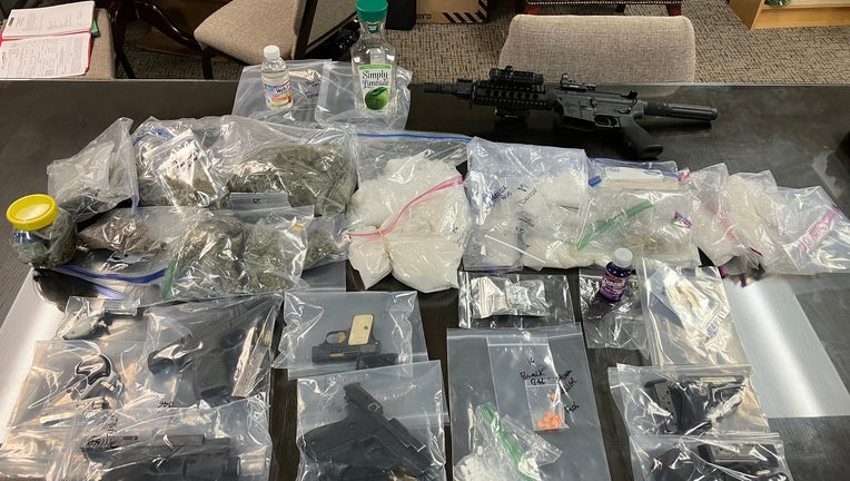 A stash of guns, drugs and cash confiscated during a narcotics investigation in Spalding County.