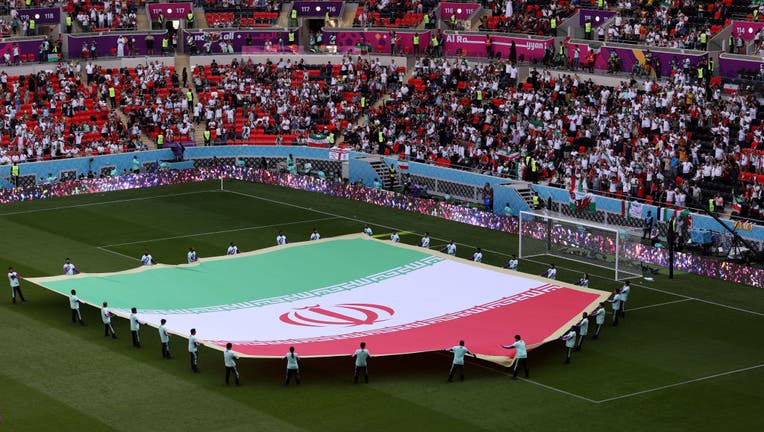 DOHA, QATAR - NOVEMBER 25: A giant flag of IR Iran on the pitch prior to the FIFA World Cup Qatar 2022 Group B match between Wales and IR Iran at Ahmad Bin Ali Stadium on November 25, 2022 in Doha, Qatar. (Photo by Catherine Ivill/Getty Images)