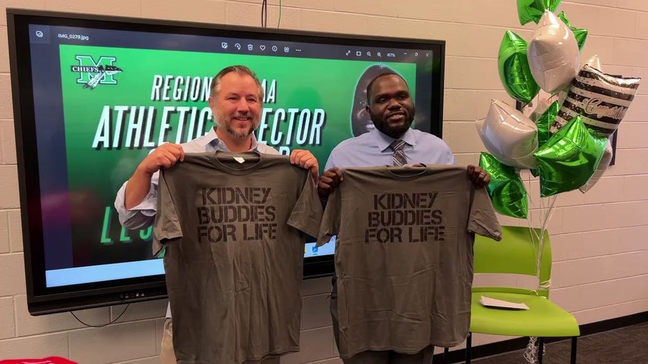 McIntosh High School’s athletic director Leon Hammond and his kidney donor, former Secret Service agent Alan Reeves, hold up matching shirts that read 