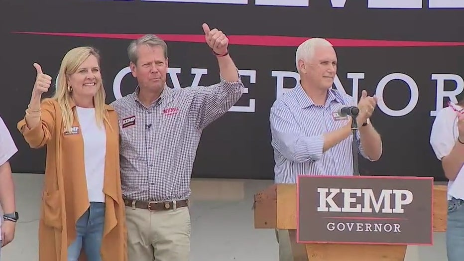 Gov. Brian Kemp and wife, Marty, give thumbs up after former Vice President Mike Pence rallies supporters during a campaign event in Forsyth County on Nov. 1, 2022.