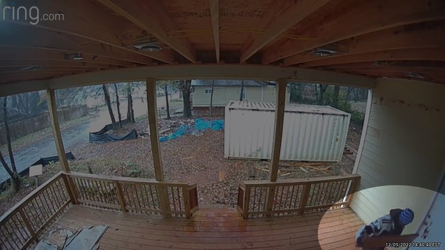 Video shows man using wood to slam door of home under construction