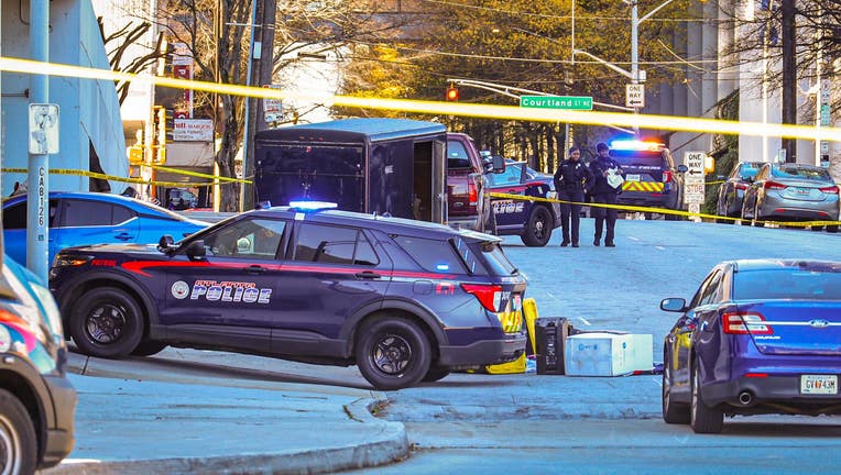 Police investigate a deadly shooting near Hilton Atlanta on Dec. 18, 2022.