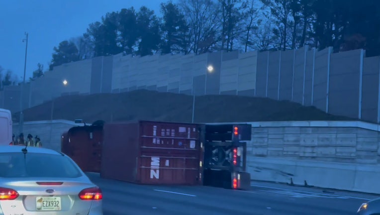 An overturned tractor-trailer blocks lanes on I-75 south. 