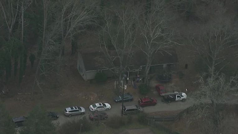 Investigators at the scene of a suspected double murder-suicide in Gainesville on Dec. 21, 2022.