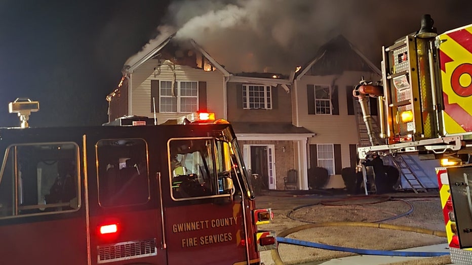 Firefighters battle a house a fire on Creek Cove Court near Loganville on Dec. 16, 2022.