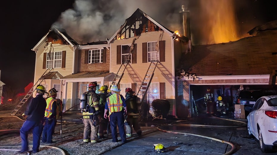Firefighters battle a house a fire on Creek Cove Court near Loganville on Dec. 16, 2022.
