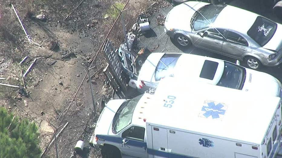 Police search for a person near an ambulance parked outside at Gwinnett County hotel.