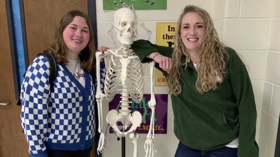 Natasha Zelinska poses with her teacher Bethany Lambert with the classroom skeleton.