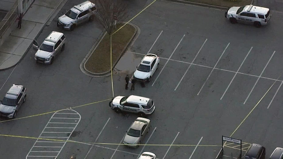Crime scene tape surrounds the parking lot of Perimeter Center West in Dunwoody on Dec. 8, 2022.