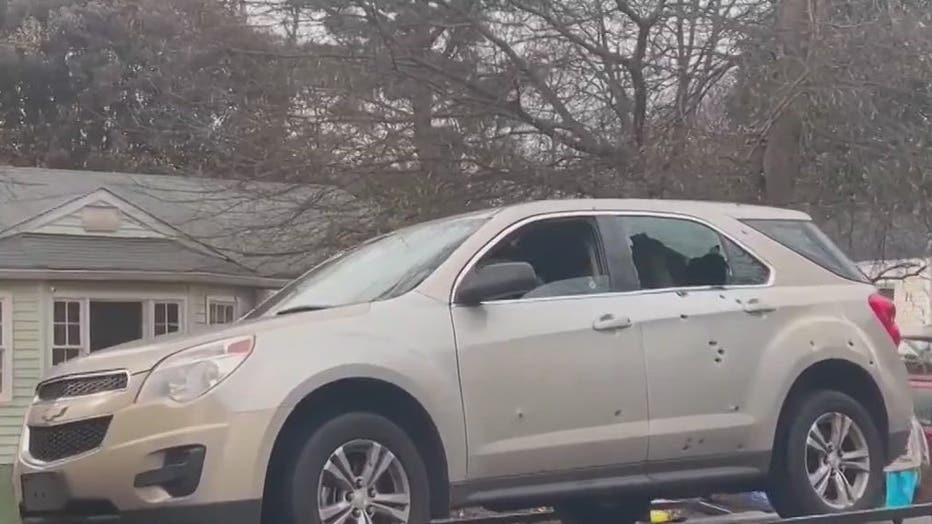 Dozens of bullet holes are seen in the side of an SUV being towed from the site of a deadly shootout in southeast Atlanta on Dec. 30, 2022.