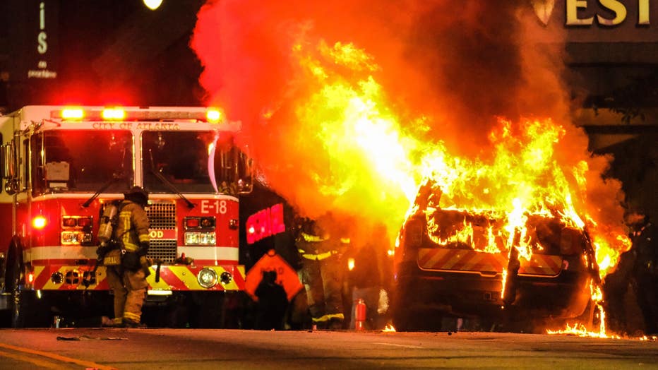 An Atlanta Police Department car burns in Downtown Atlanta on Jan. 21, 2023.