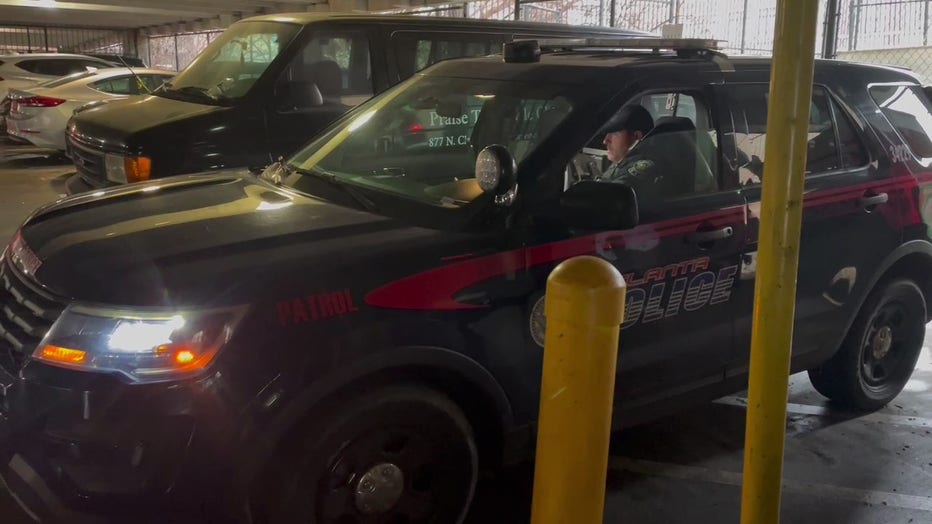 Atlanta police investigate after about two dozen vehicles were targeted for break-ins by three crooks in the garage of a Downtown Atlanta apartment building on the morning of Jan. 18, 2023.