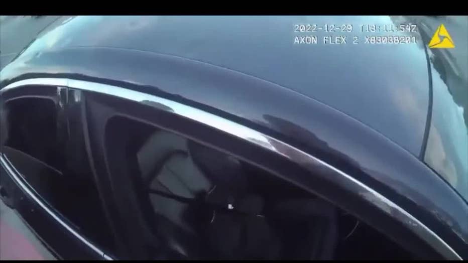 This image from a Coweta County Sheriff's deputy body cam shows a traffic stop where investigators say stolen cigarettes were found.