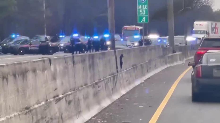 Atlanta police investigate the end of a brief chase that ended along I-20 just west of Downtown on Feb. 2, 2023.