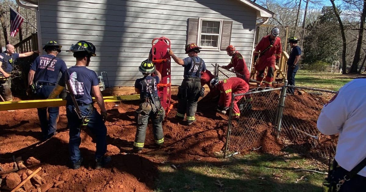 Photos show rescue of Woodstock man 'buried up to his neck' in ...