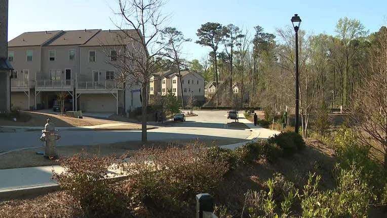 Police investigate after a body was found in a pond near a Doraville apartment on March 23, 2023.