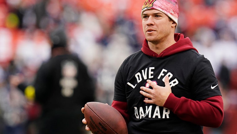 LANDOVER, MARYLAND - JANUARY 08: Quarterback Taylor Heinicke #4 of the Washington Commanders warms up prior tot he game against the Dallas Cowboys at FedExField on January 08, 2023 in Landover, Maryland. (Photo by Jess Rapfogel/Getty Images)